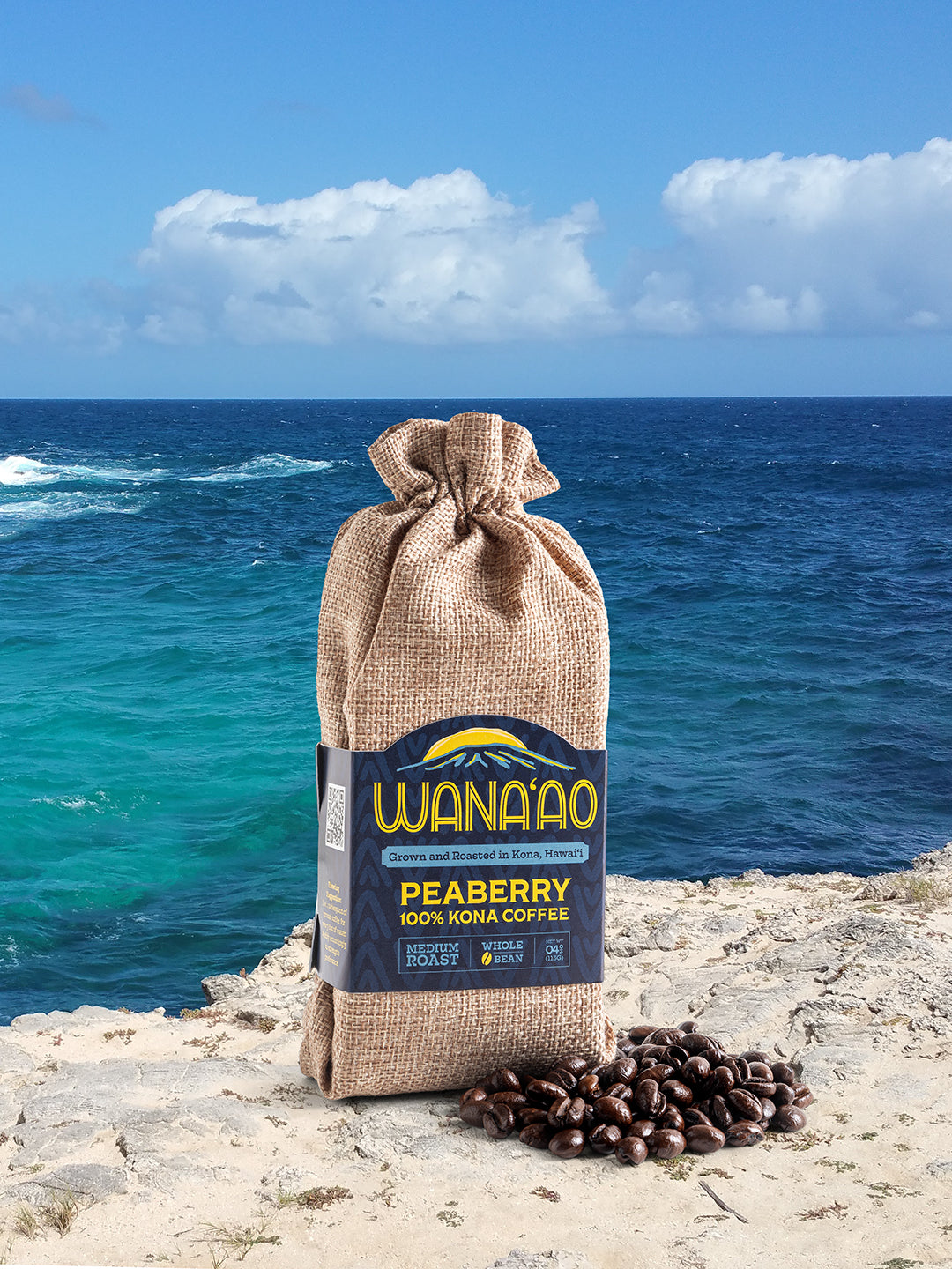 Wana'ao 100% Kona Peaberry Coffee 4 oz bag on a Hawaii ocean cliff