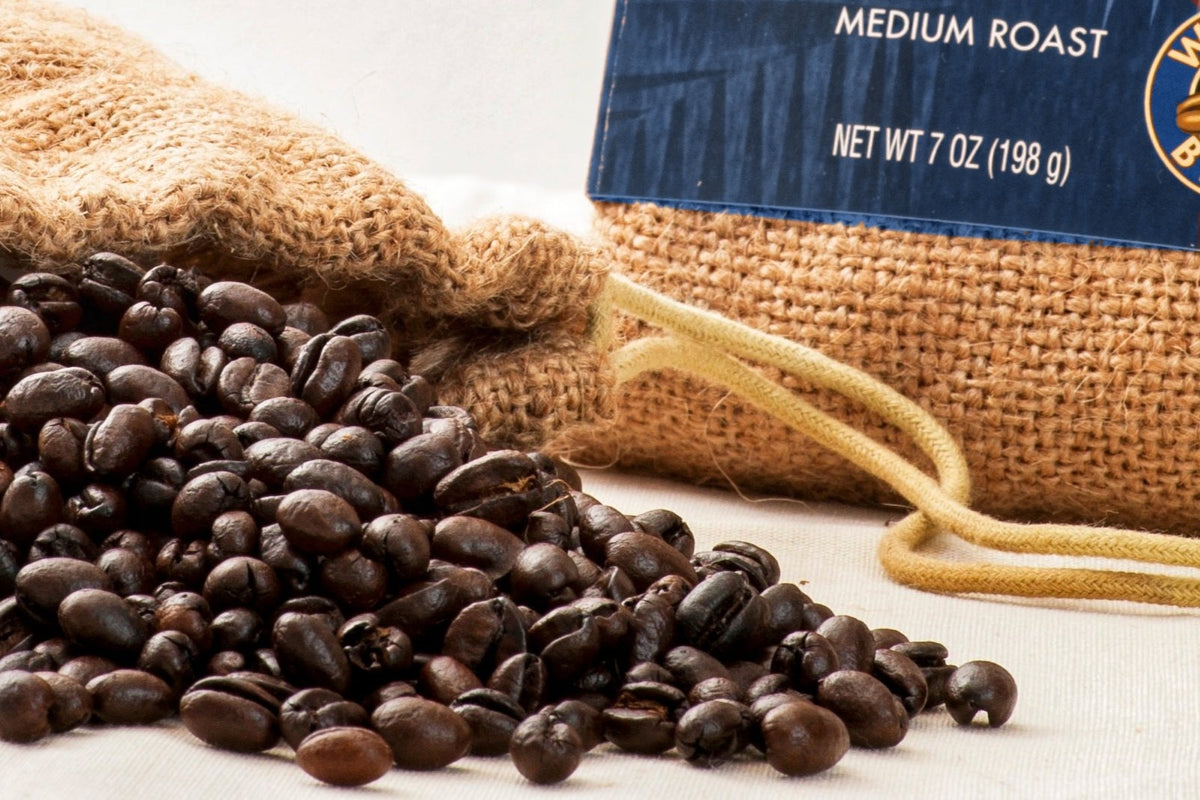 Wana'ao 100% Kona Peaberry Coffee 7 oz burlap bag with blue label and roasted beans